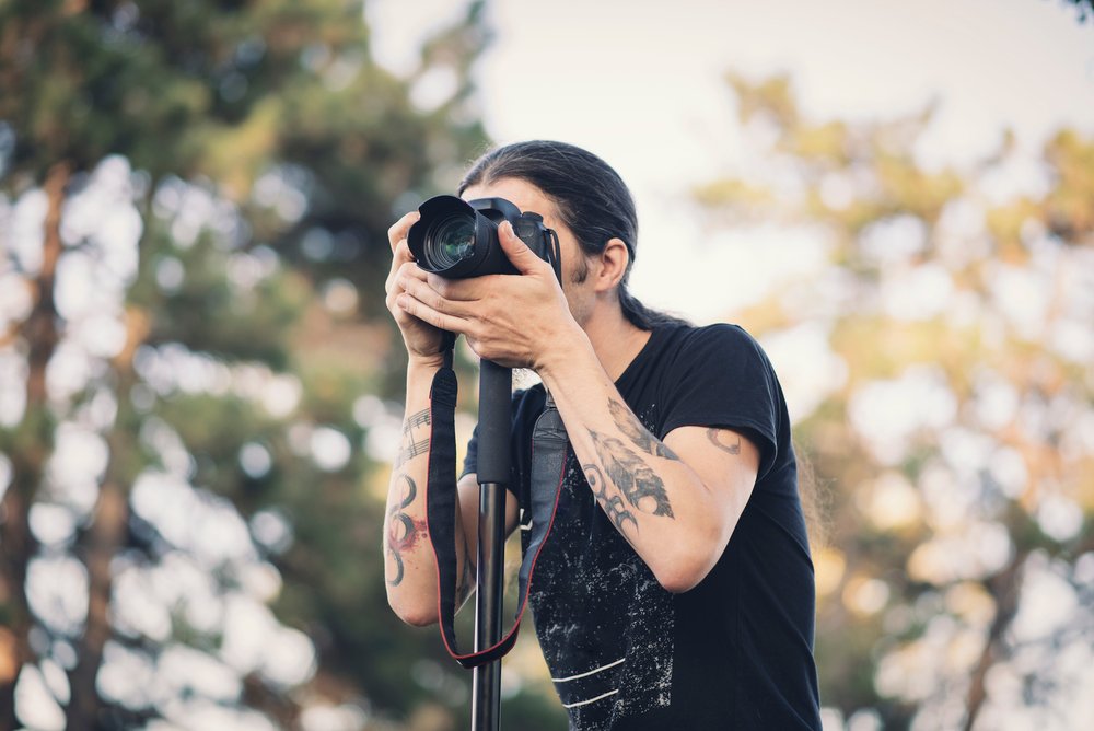 Young photographer with a monopod